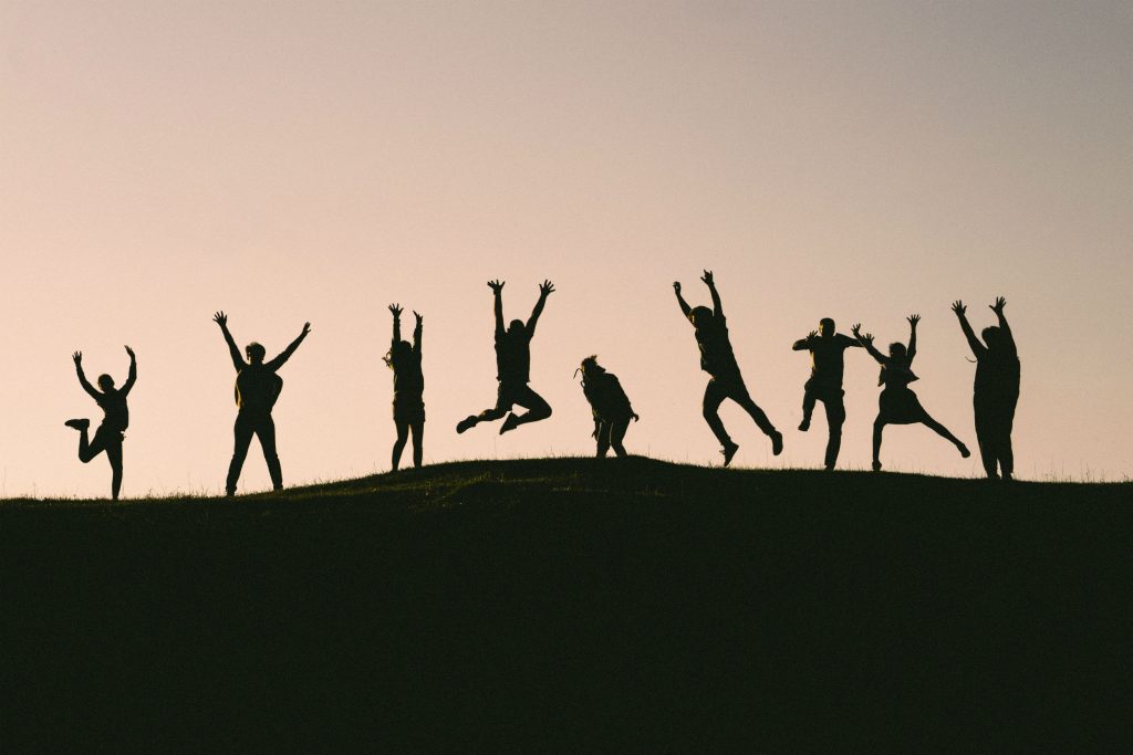 silhouette photo of group of people on mountain